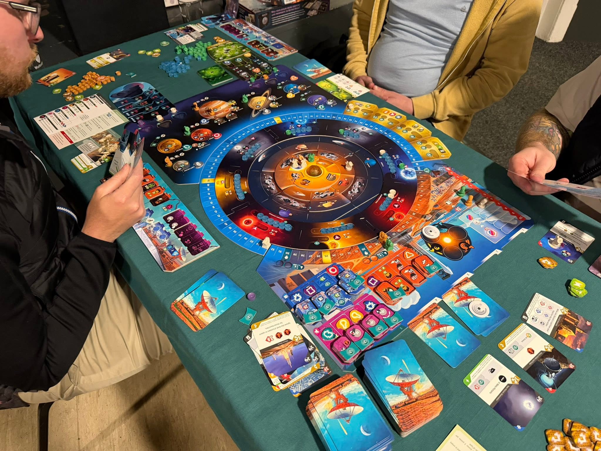 Players around a space-themed board game